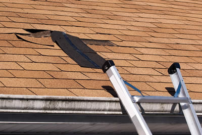Residential home with storm damaged asphalt shingles