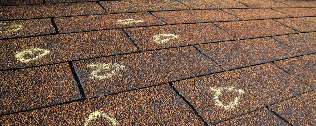 Chalk marked hail damages on a roof