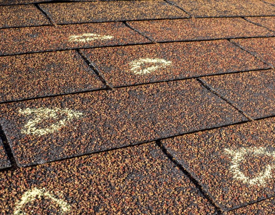 Chalk marked hail damages on a roof