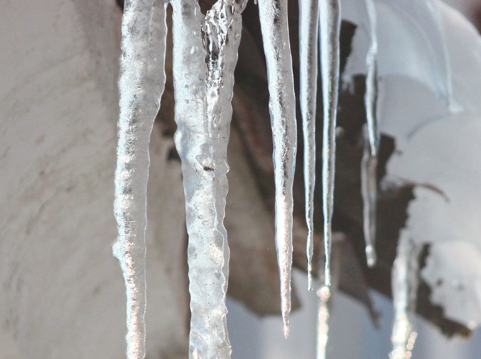 Icicles on a snow covered roof
