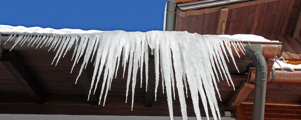 Large icicles hanging from a house roof